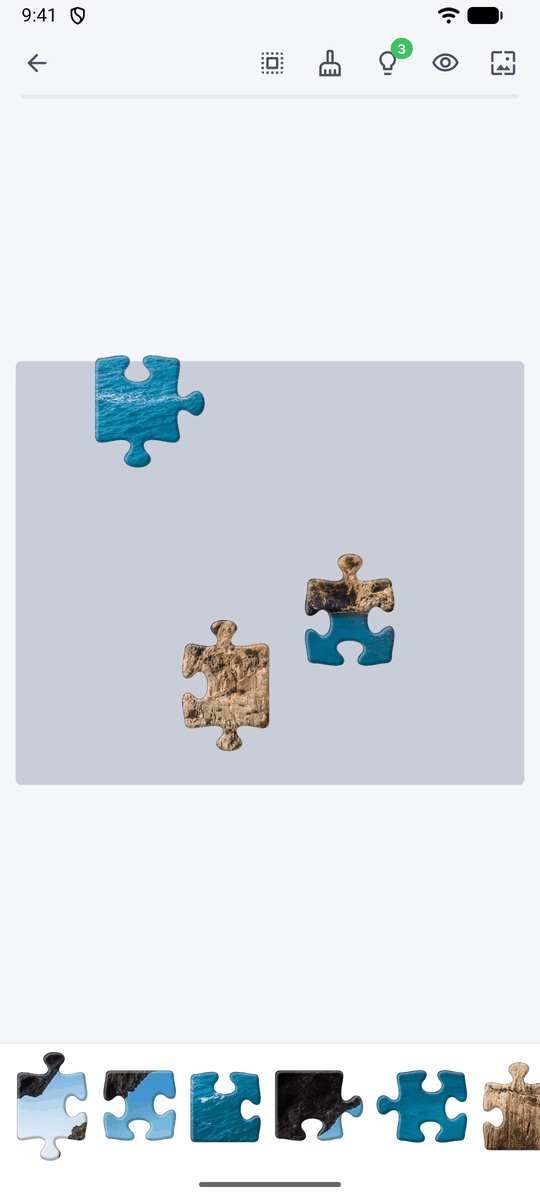 The first few jigsaw pieces placed on the board, with more pieces waiting in the tray